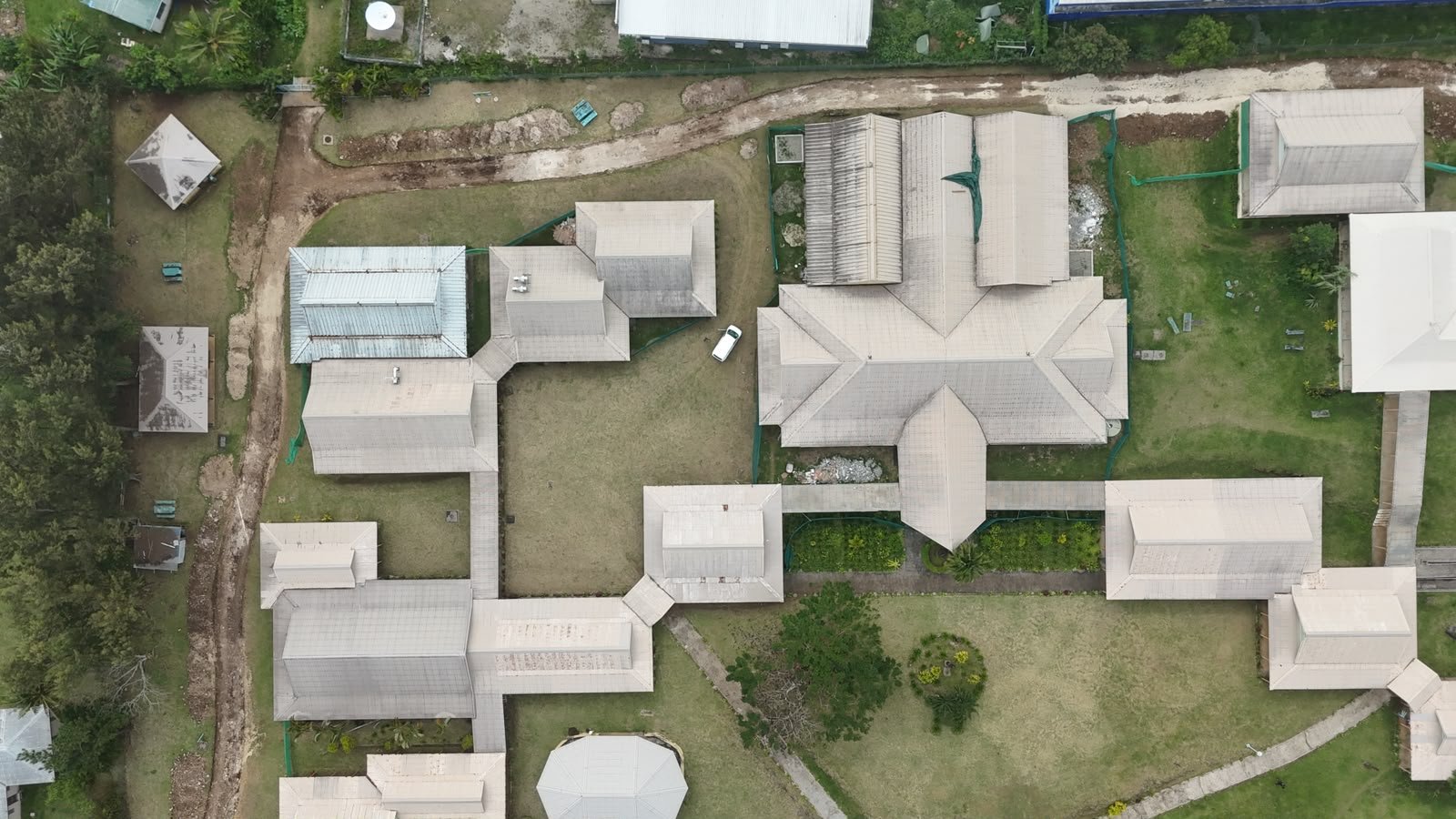 Aerial and ground-level views showing ongoing renovation works at the USP Library, including building repairs, site preparation, and safety measures currently in place.